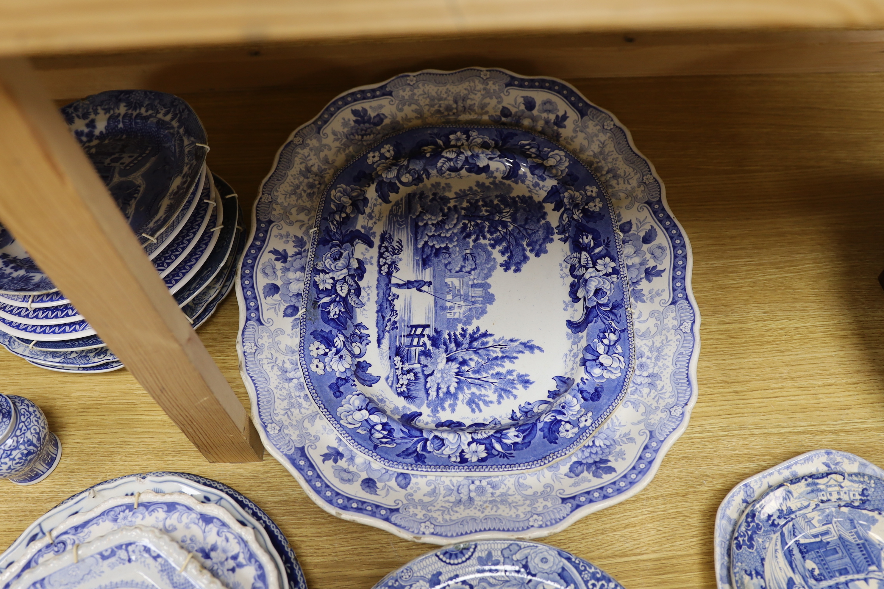 An early 19th century John Meir and Sons blue and white printed 'Fairy Villas' meat dish together with a collection of Staffordshire and other blue and white dishes and two baluster jars and covers, the largest 50cm wide